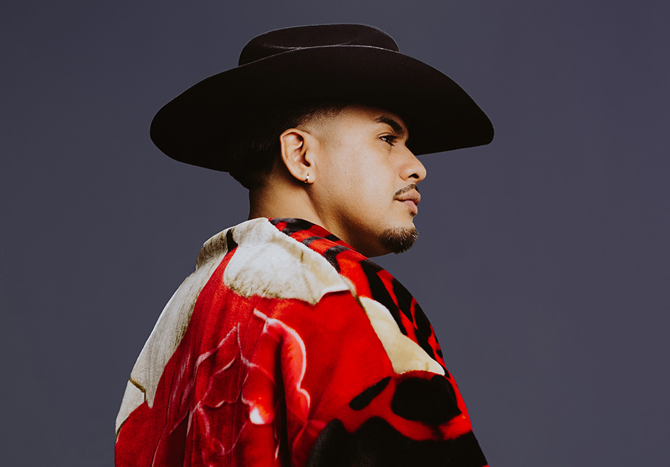 Profile view of Yosimar Reyes dressed for his one-man show, Prieto