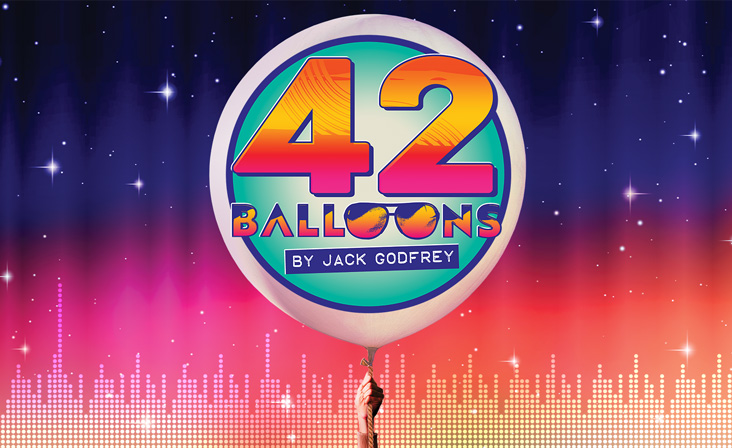 "42 Balloons," a new musical by Jack Godfrey, featuring a large balloon with colorful text against a night sky background.