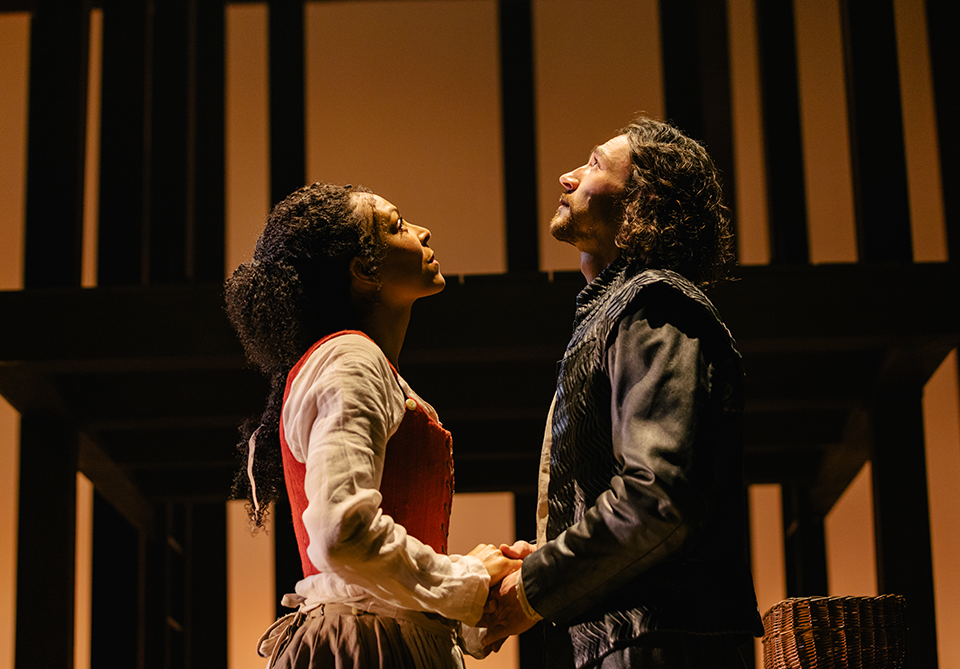 a man and woman holding each others hands as they stare up to the skies
